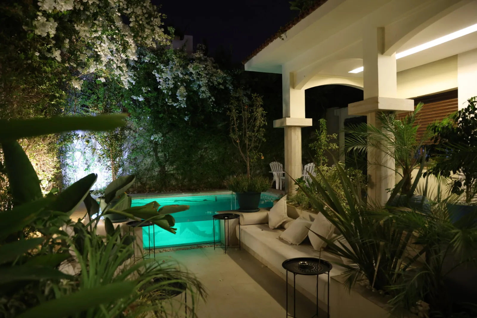 The garden and lit pool at Riad Sebti after dark.